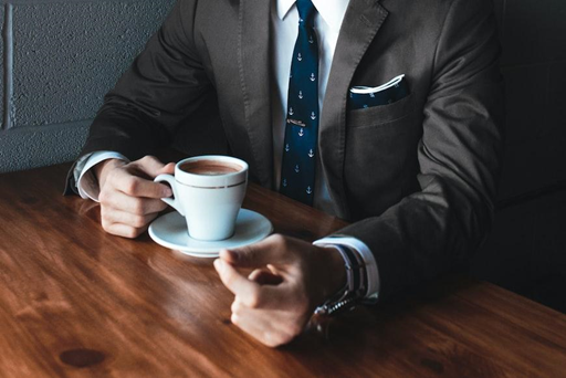 Sneak Peek: How Essay Writers for Hire Adapt to AI Craziness 1 man in suit drinking tea